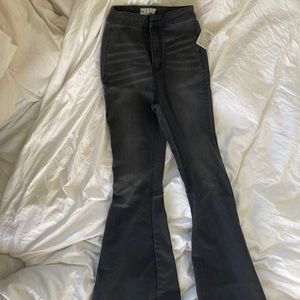Free people just float on black bell bottom jeans.